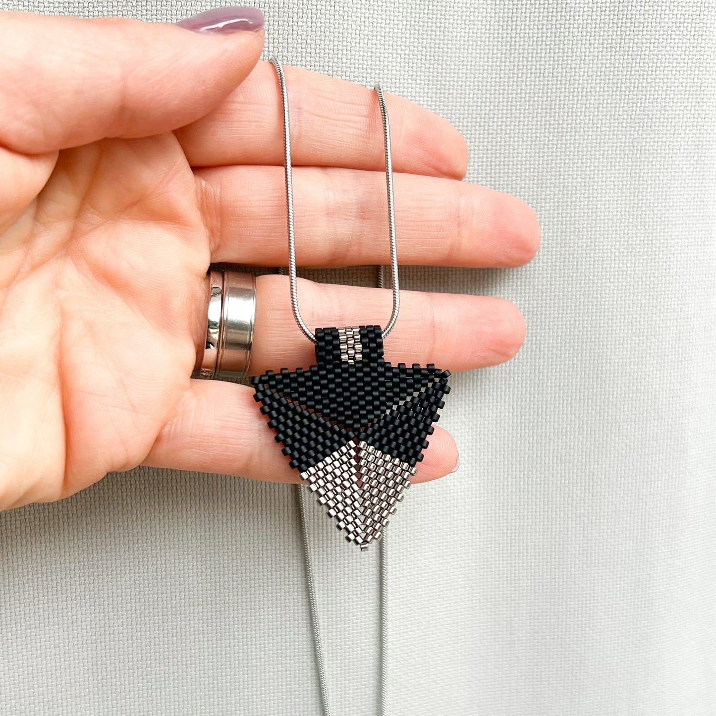 Colier modern cu pandantiv triunghiular din margele negre si argintii